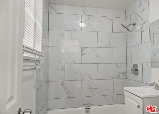 an empty room with wooden floor and mirror