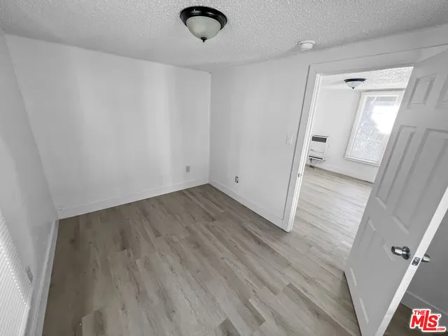 a view of a city with lots of residential buildings ocean and mountain view in back