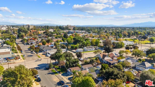 an aerial view of a house with outdoor space and a fountain