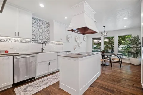 a kitchen with a sink cabinets and wooden floor