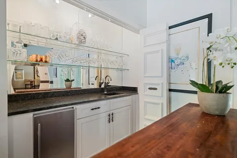 a kitchen with white cabinets and a sink