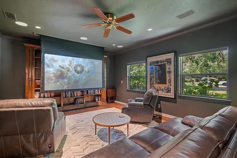 a living room with furniture a large window and a flat screen tv