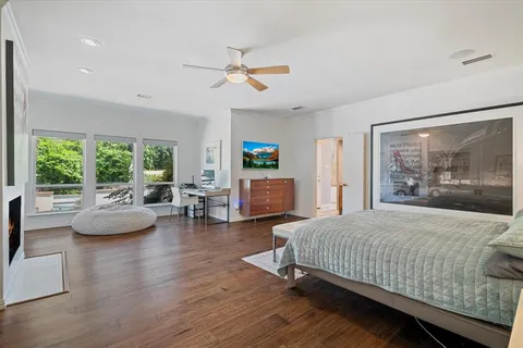 a bedroom with a bed and a large window