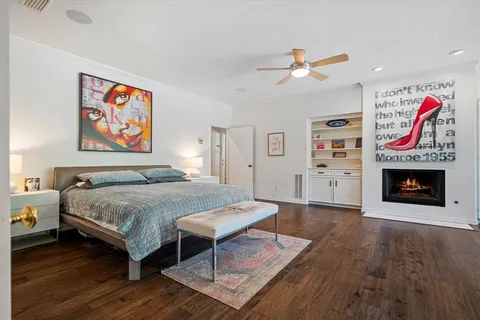 a spacious bedroom with a bed and a fireplace