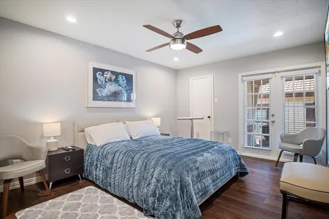 a bed room with a bed and a painting on the wall