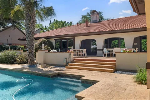 a view of a white house with a swimming pool