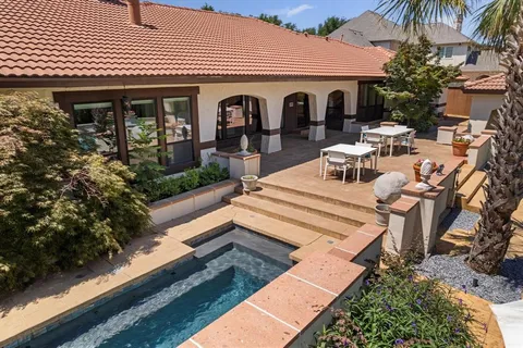 a view of a patio with couches table and chairs and potted plants