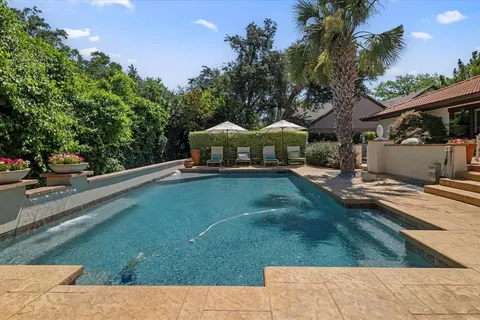 a view of a patio with chair and tables
