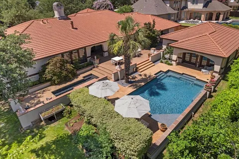 an aerial view of a house with garden space and street view