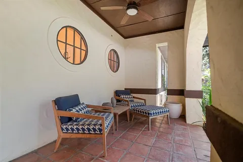 a view of a room with chairs and a mirror
