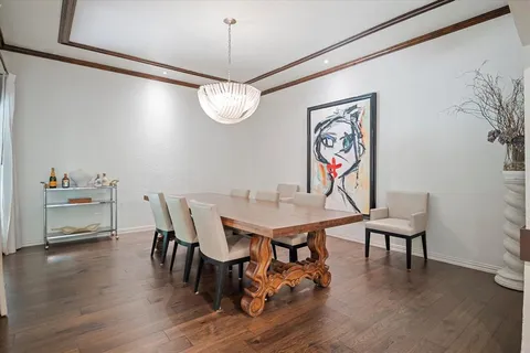 a view of a dining room with furniture wooden floor and chandelier