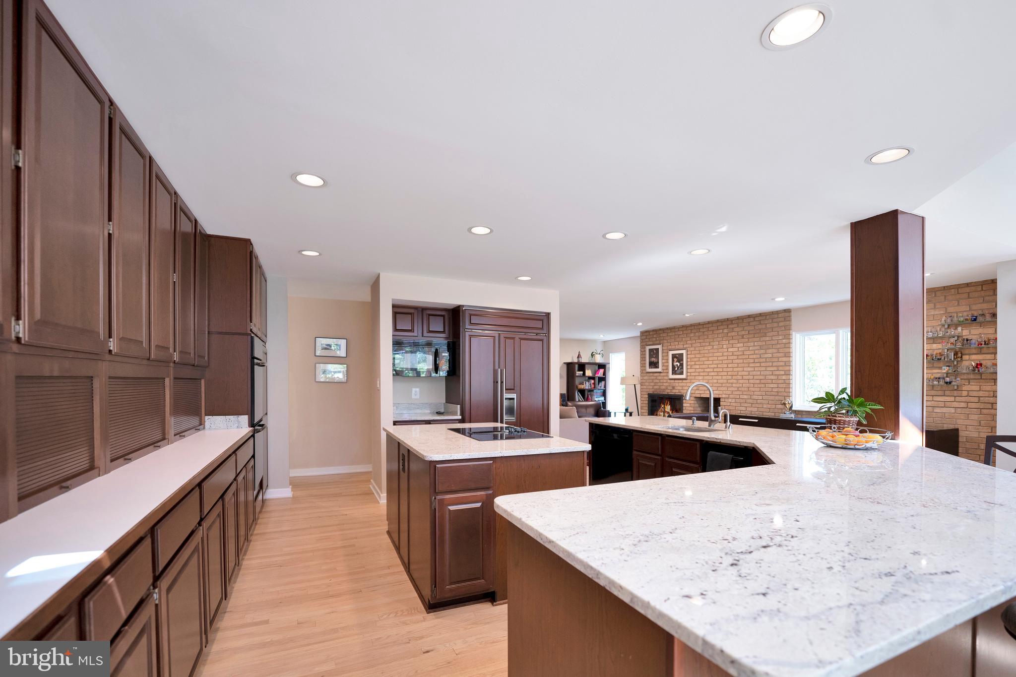 3214 Foxvale Drive Oakton, VA 22124 - Photo 14 of 56 a large kitchen with stainless steel appliances kitchen island a large counter top and a stove