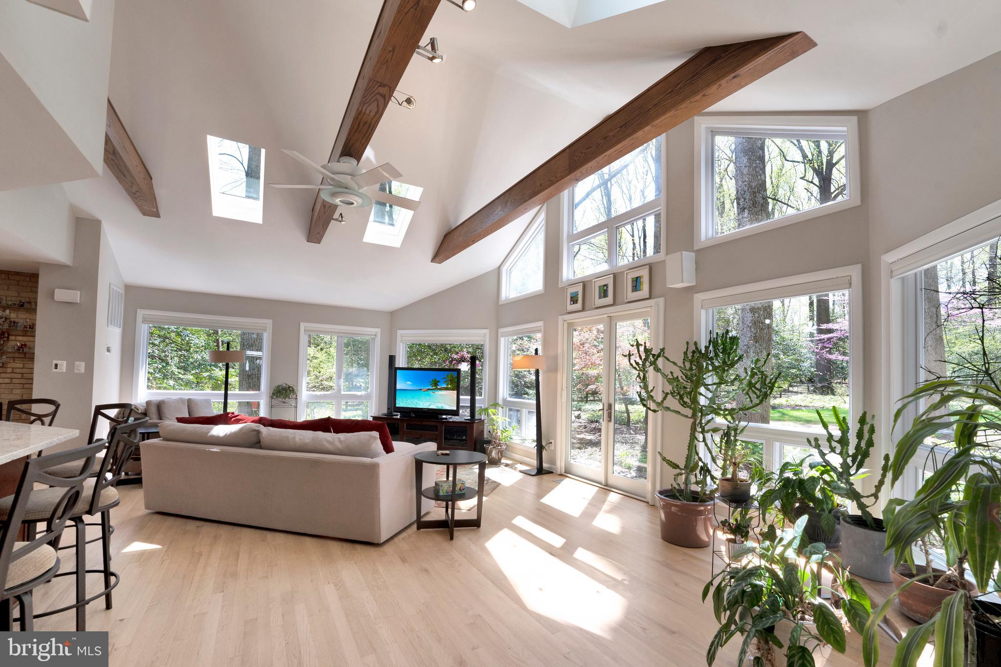 3214 Foxvale Drive Oakton, VA 22124 - Photo 16 of 56 a living room with furniture potted plant floor to ceiling windows and a chandelier