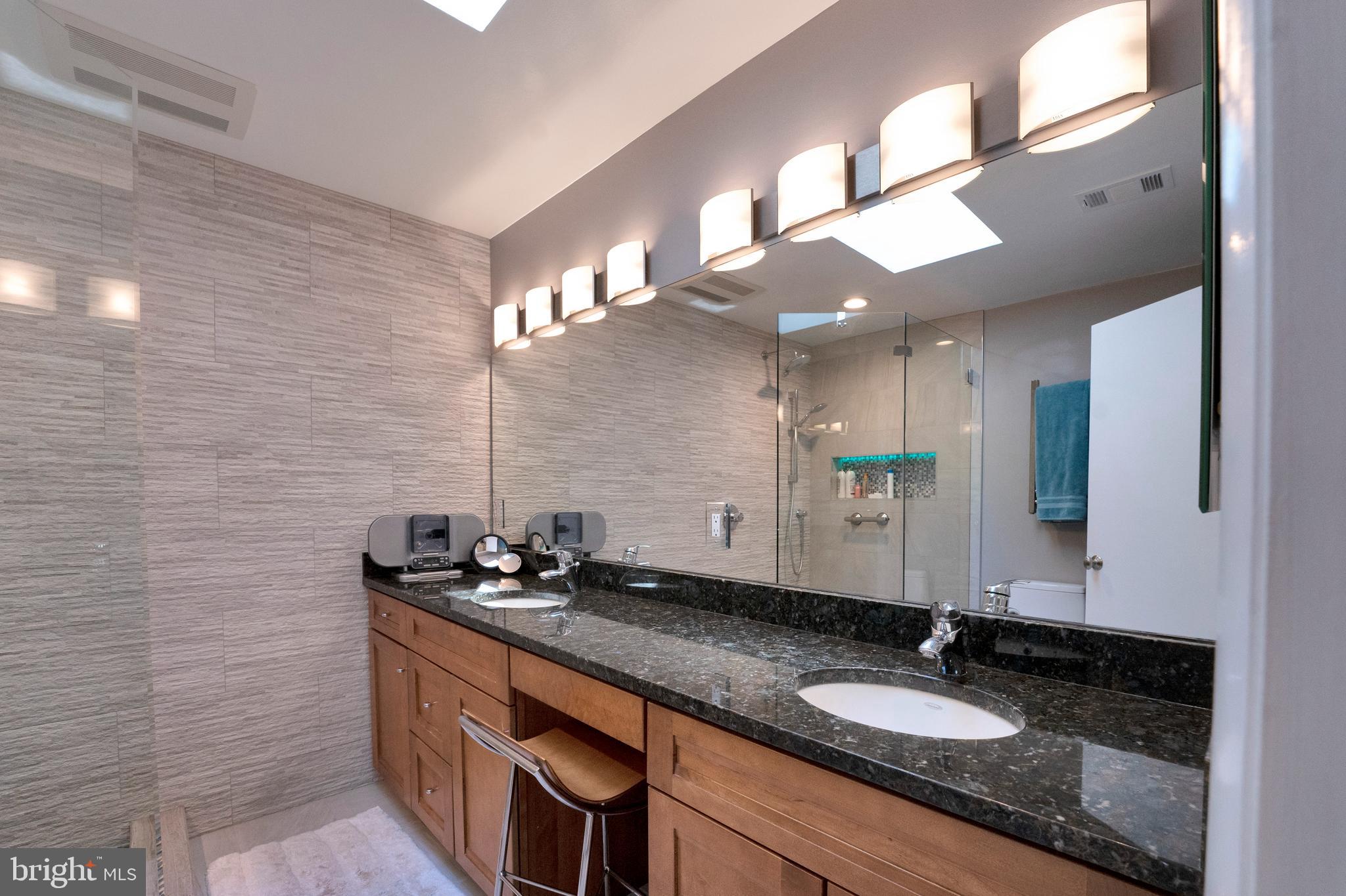 3214 Foxvale Drive Oakton, VA 22124 - Photo 27 of 56 a bathroom with a granite countertop sink a large mirror and vanity