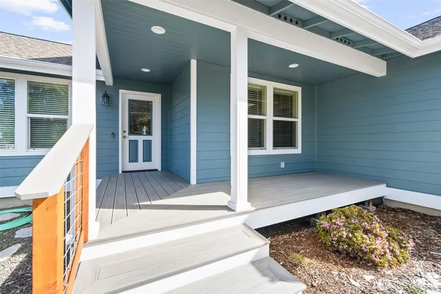 a view of a house with wooden floor and a large window