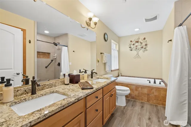 a bathroom with a granite countertop sink toilet and shower