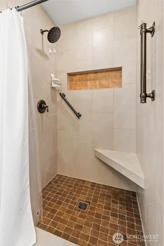 a balcony with wooden floor table and chairs