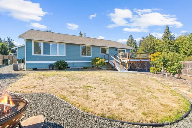 a view of a house with a yard and potted plants