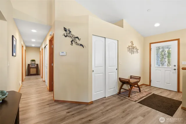 a living room with furniture flat screen tv and a large window