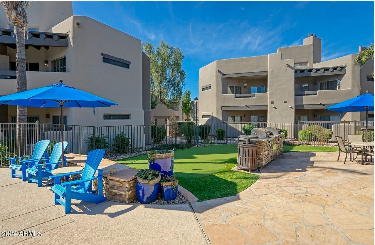 9259 East Raintree Drive, Unit 2 Scottsdale, AZ 85260 - Photo 11 of 13 a view of a building with sitting area and furniture