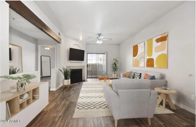 a living room with furniture a fireplace and a flat screen tv