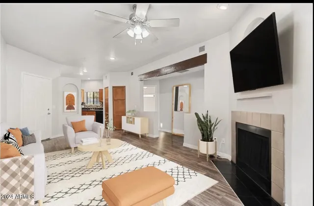 a living room with furniture a fireplace and flat screen tv