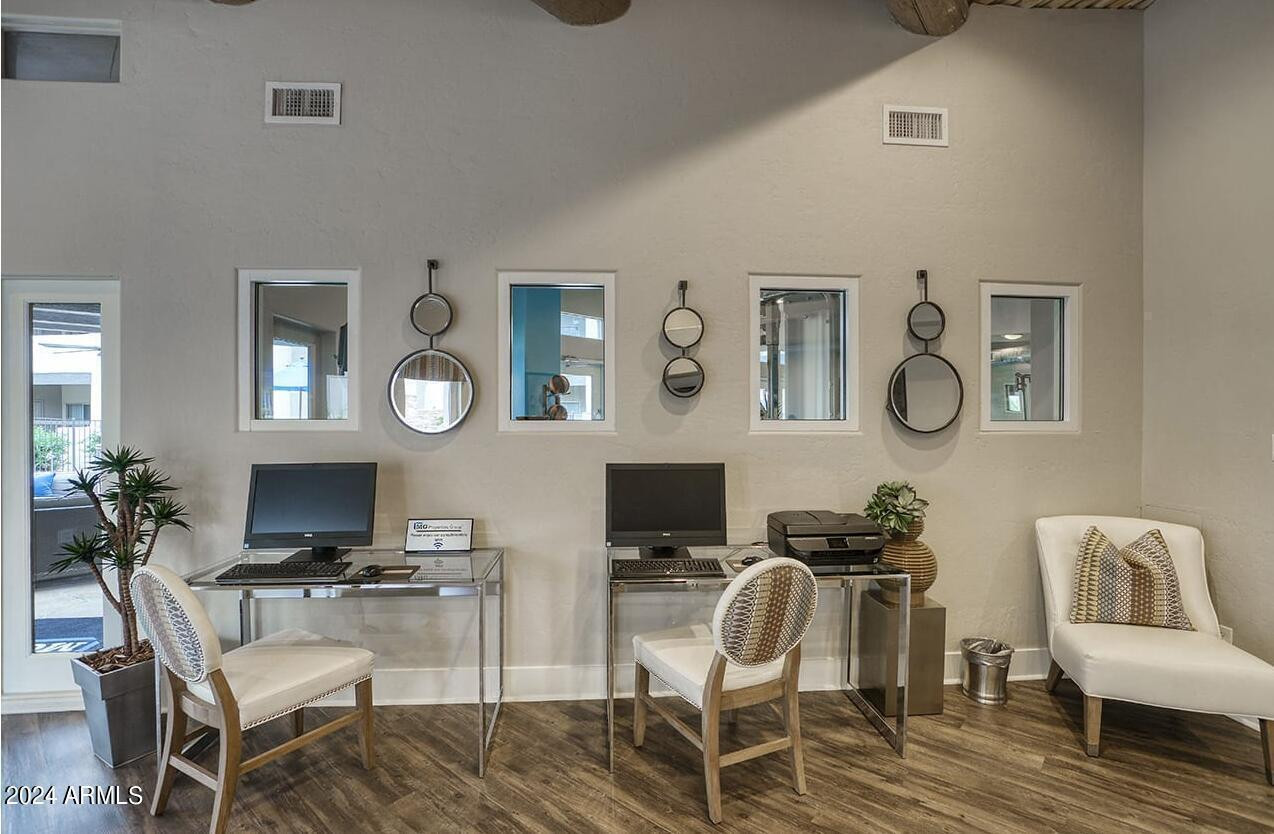 9259 East Raintree Drive, Unit 2 Scottsdale, AZ 85260 - Photo 7 of 13 a living room with furniture a flat screen tv and a table