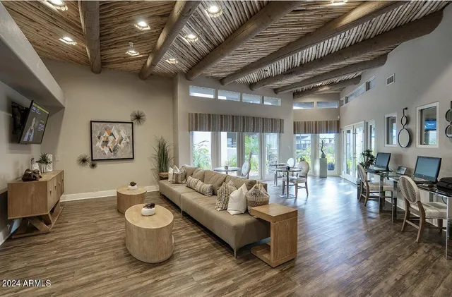 a living room with furniture and wooden floor