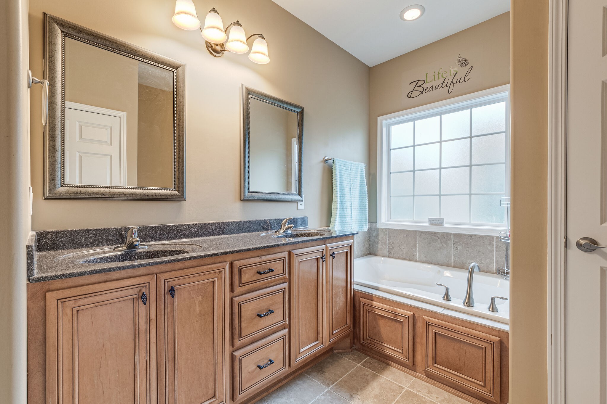 2113 Burford Road Lebanon, TN 37087 - Photo 22 of 35 a bathroom with a granite countertop double vanity sink a mirror and a bathtub