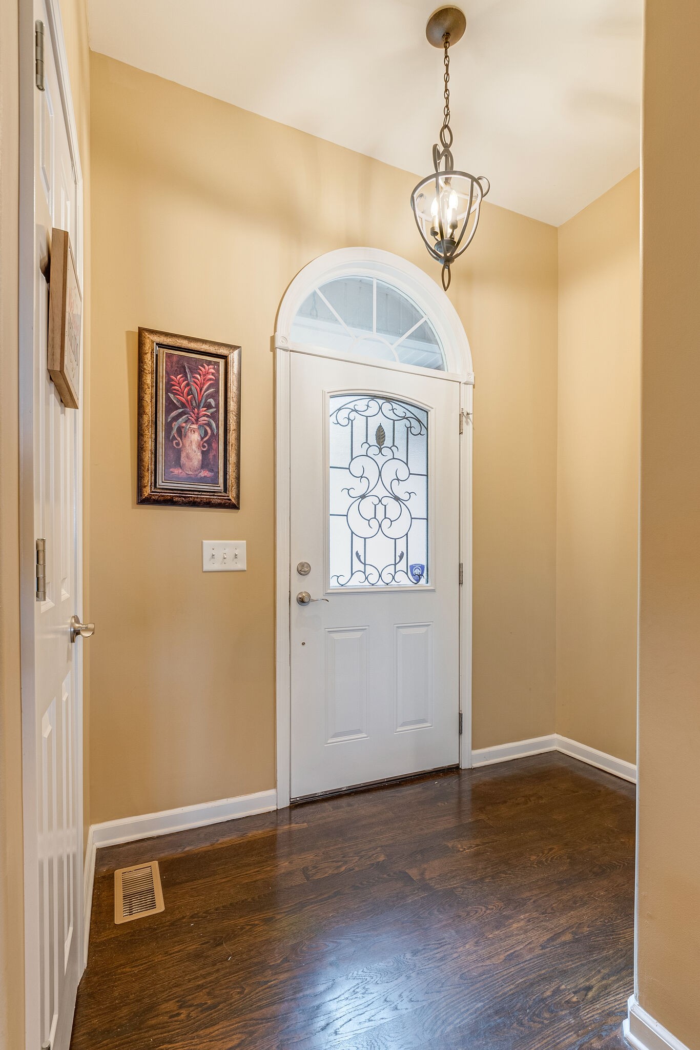 2113 Burford Road Lebanon, TN 37087 - Photo 4 of 35 a view of a hallway with wooden floor and a chandelier