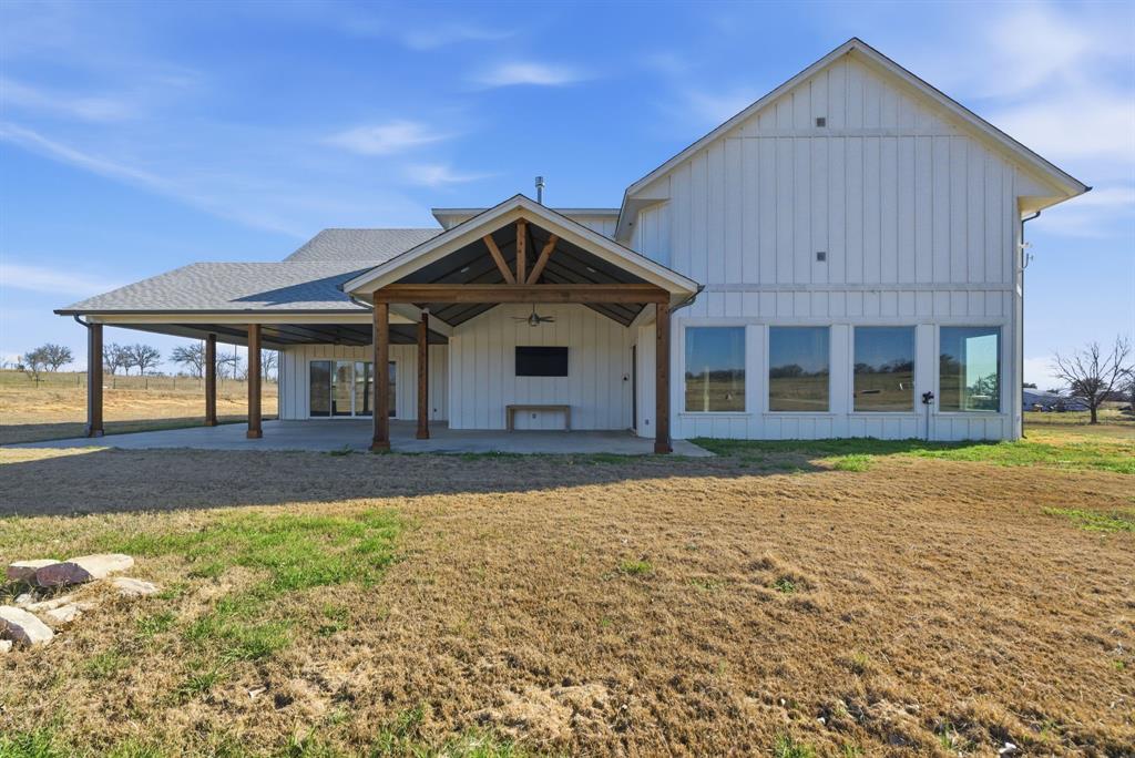 4600 A Old Brock Road Weatherford, TX 76087 - Photo 39 of 40 Back of house with board and batten siding, a yard, and a patio area