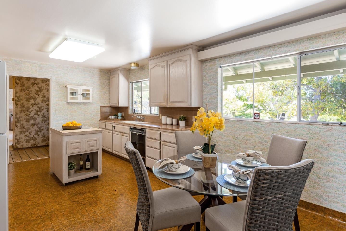 20184 Pierce Road Saratoga, CA 95070 - Photo 11 of 30 a dining room with furniture a fireplace and wooden floor