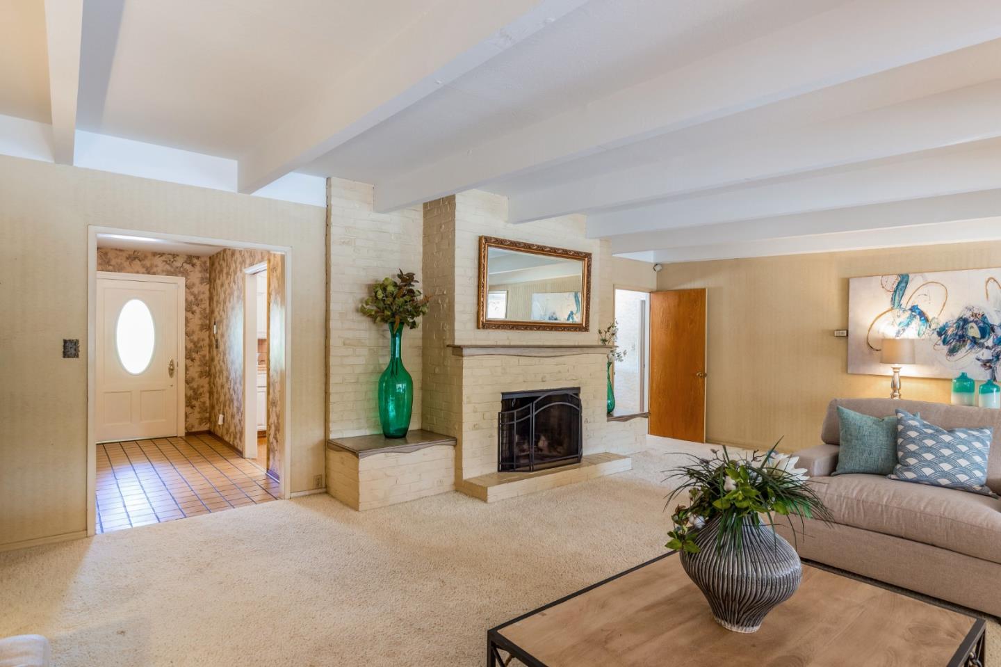 20184 Pierce Road Saratoga, CA 95070 - Photo 6 of 30 a living room with furniture a fireplace and a potted plant
