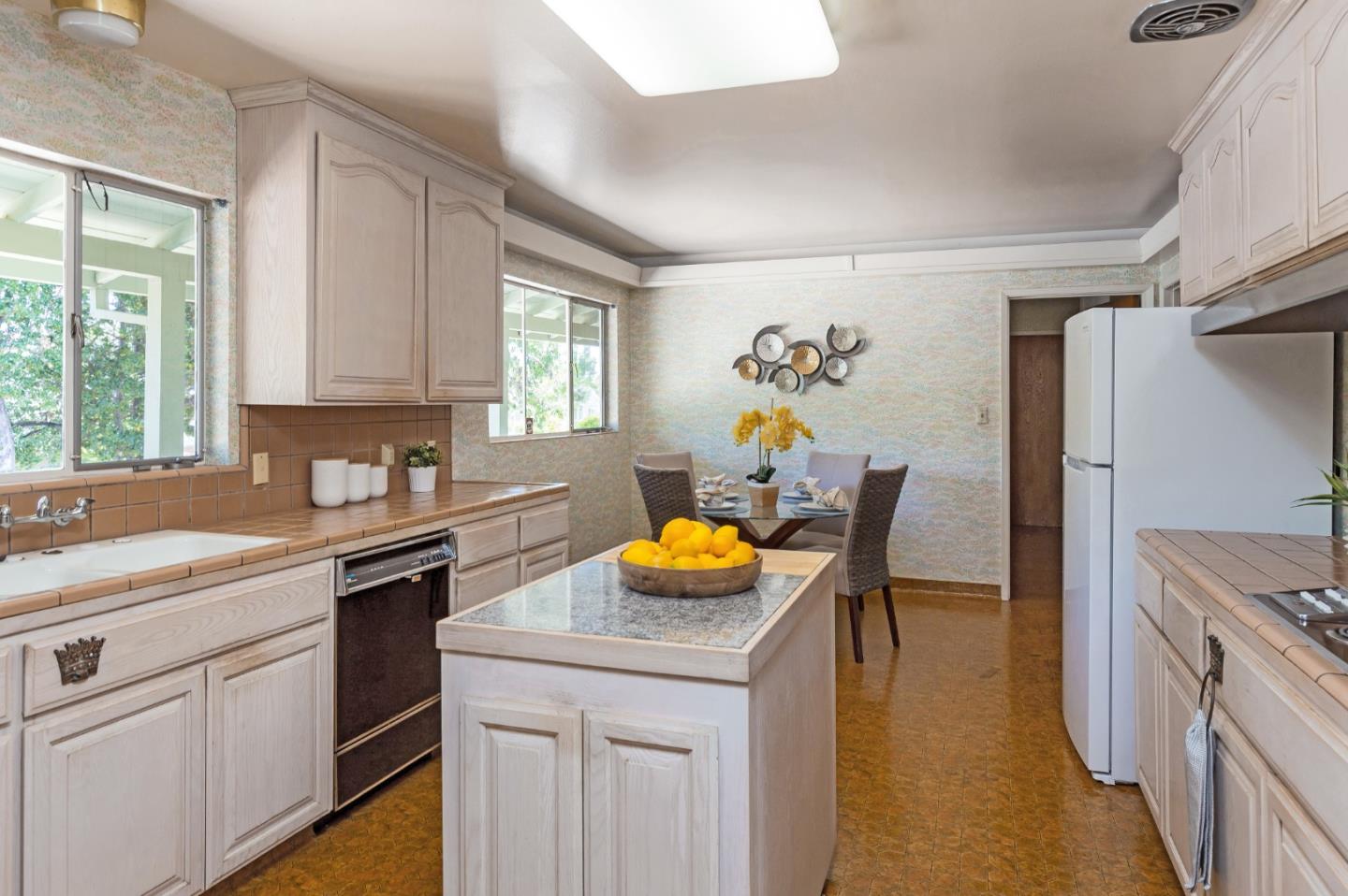 20184 Pierce Road Saratoga, CA 95070 - Photo 9 of 30 a kitchen with stainless steel appliances kitchen island granite countertop a sink cabinets and window