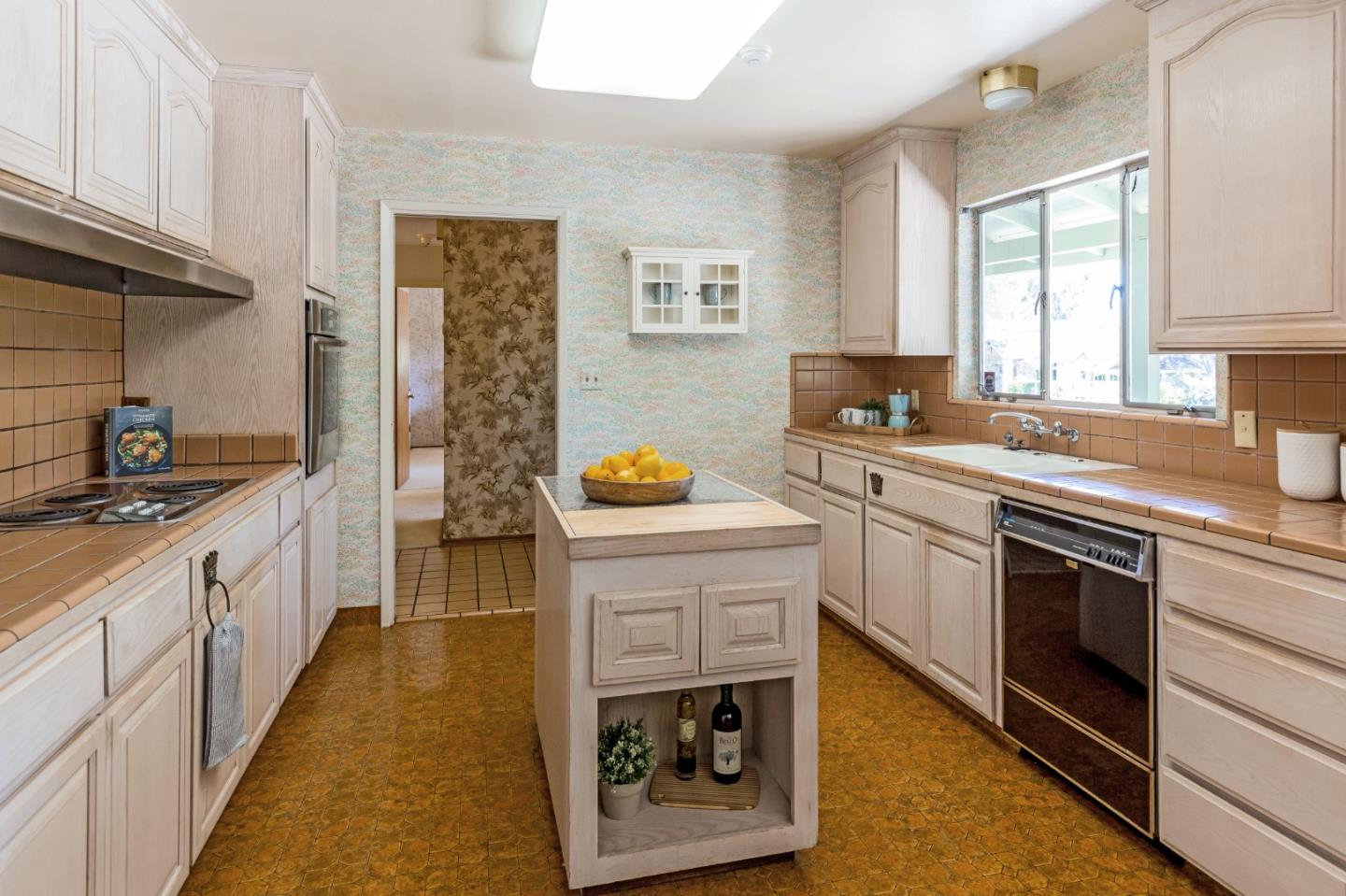 20184 Pierce Road Saratoga, CA 95070 - Photo 10 of 30 a kitchen with a sink stove and cabinets