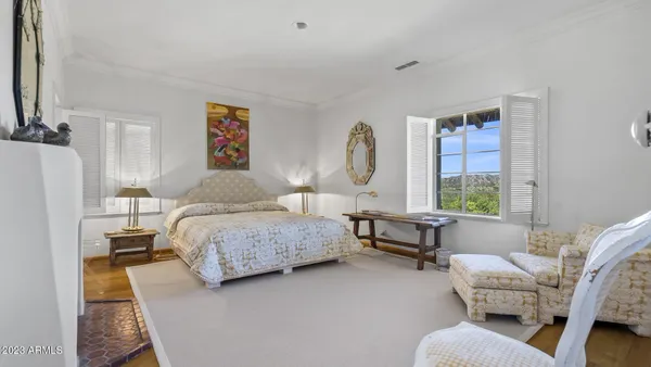 a bedroom with a bed a table and chair
