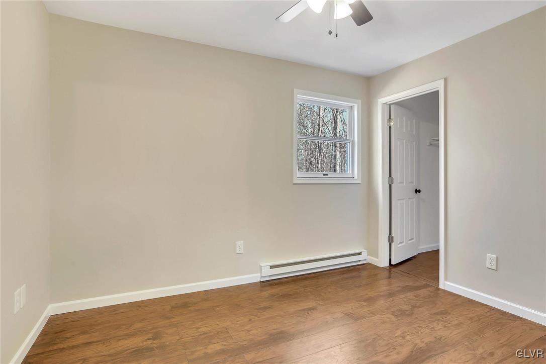 111 Brewster Way East Stroudsburg, PA 18301 - Photo 17 of 30 an empty room with a chandelier fan and windows