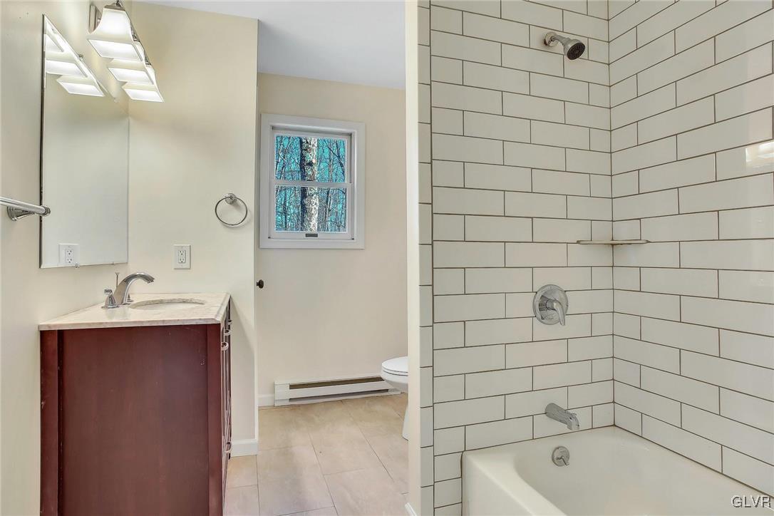 111 Brewster Way East Stroudsburg, PA 18301 - Photo 19 of 30 a bathroom with a bathtub shower sink and mirror