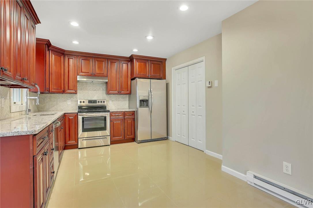 111 Brewster Way East Stroudsburg, PA 18301 - Photo 3 of 30 a kitchen with stainless steel appliances a refrigerator and a stove top oven