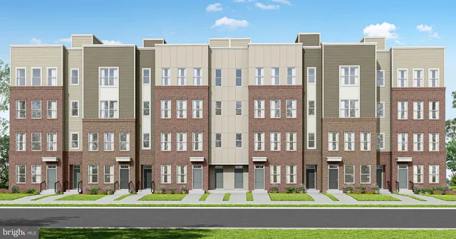 a front view of a residential apartment building with a yard