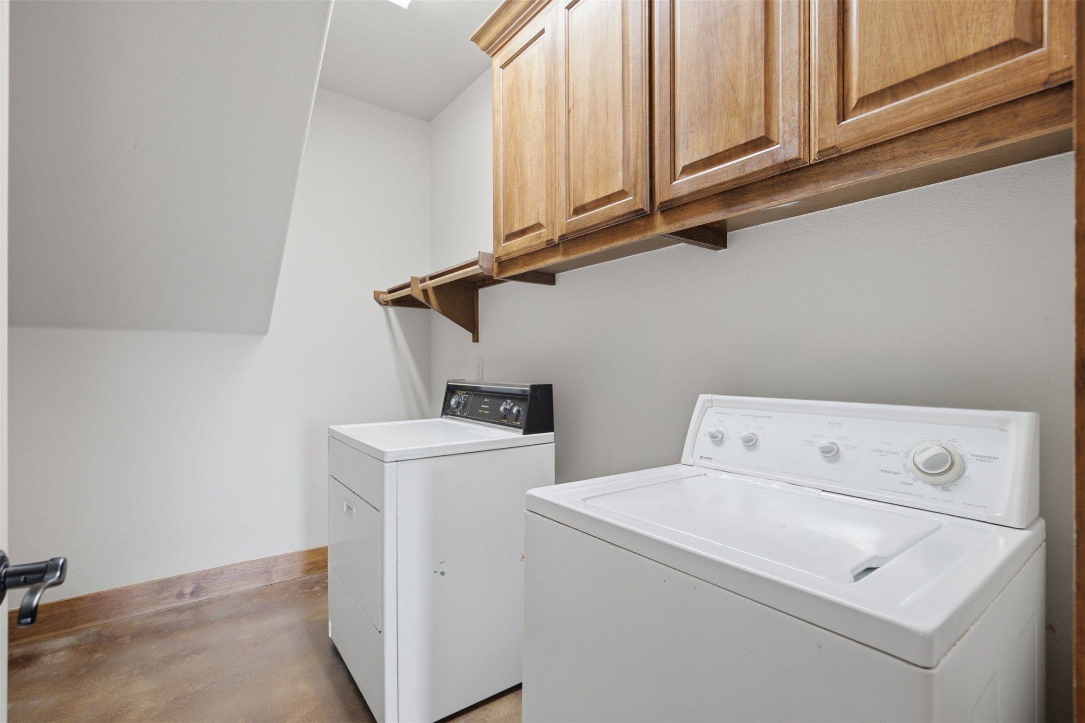 700 Augusta Circle Point Venture, TX 78645 - Photo 19 of 35 Ample wooden cabinetry and convenient hookups provide a functional laundry space.