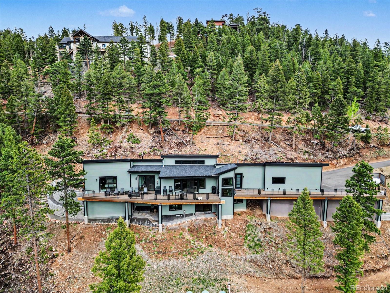 7231 Timber Trail Road Evergreen, CO 80439 - Photo 33 of 35 an aerial view of a house with swimming pool and outdoor seating