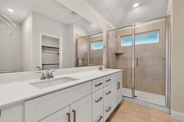 a bathroom with a shower sink and mirror