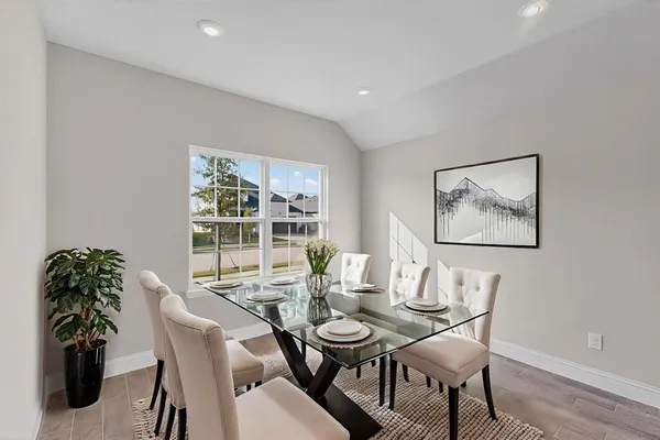 a view of a dining room with furniture window and wooden floor