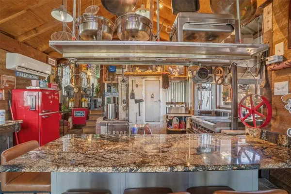 a kitchen with a table chairs and cabinets