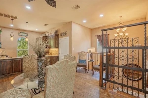 a kitchen with stainless steel appliances granite countertop a sink a stove and a wooden cabinets