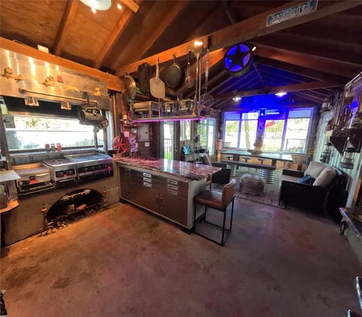 a kitchen with stainless steel appliances granite countertop a sink a stove and cabinets