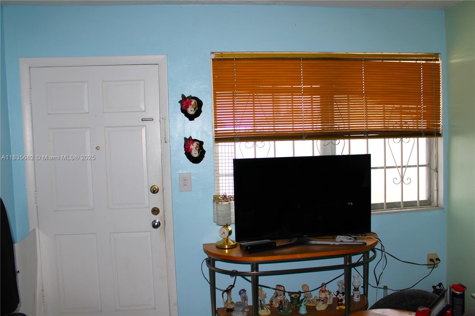 1154 West 35th Street, Unit 221 Hialeah, FL 33012 - Photo 19 of 39 a living room with a flat screen tv and a window
