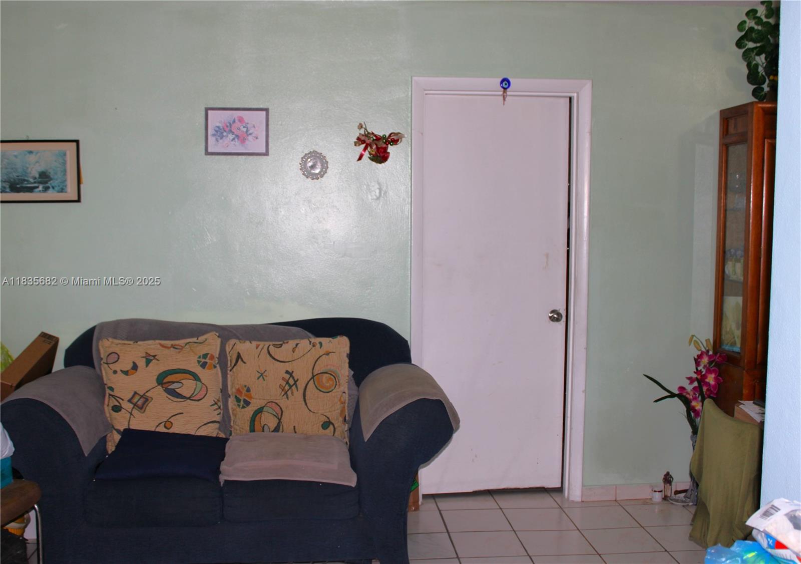 1154 West 35th Street, Unit 221 Hialeah, FL 33012 - Photo 24 of 39 a bedroom with a bed and a potted plant on the dresser