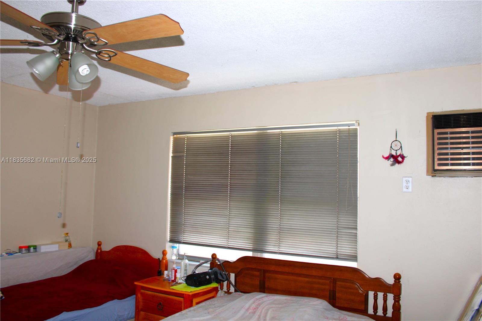 1154 West 35th Street, Unit 221 Hialeah, FL 33012 - Photo 27 of 39 a bedroom with furniture and a window